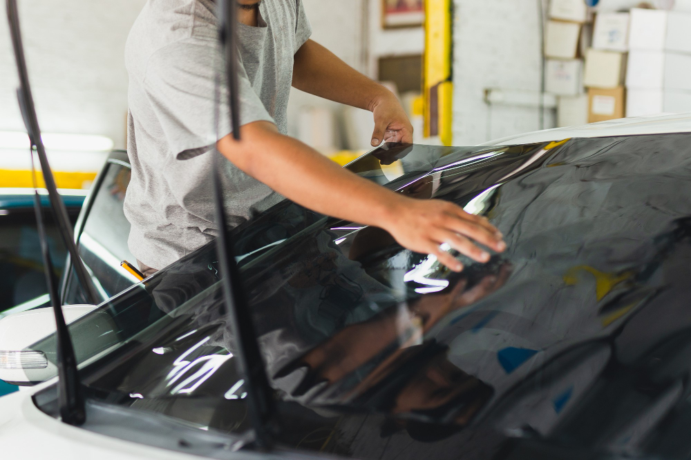 car-specialist-applying-tinting-foil-car-window-auto-service