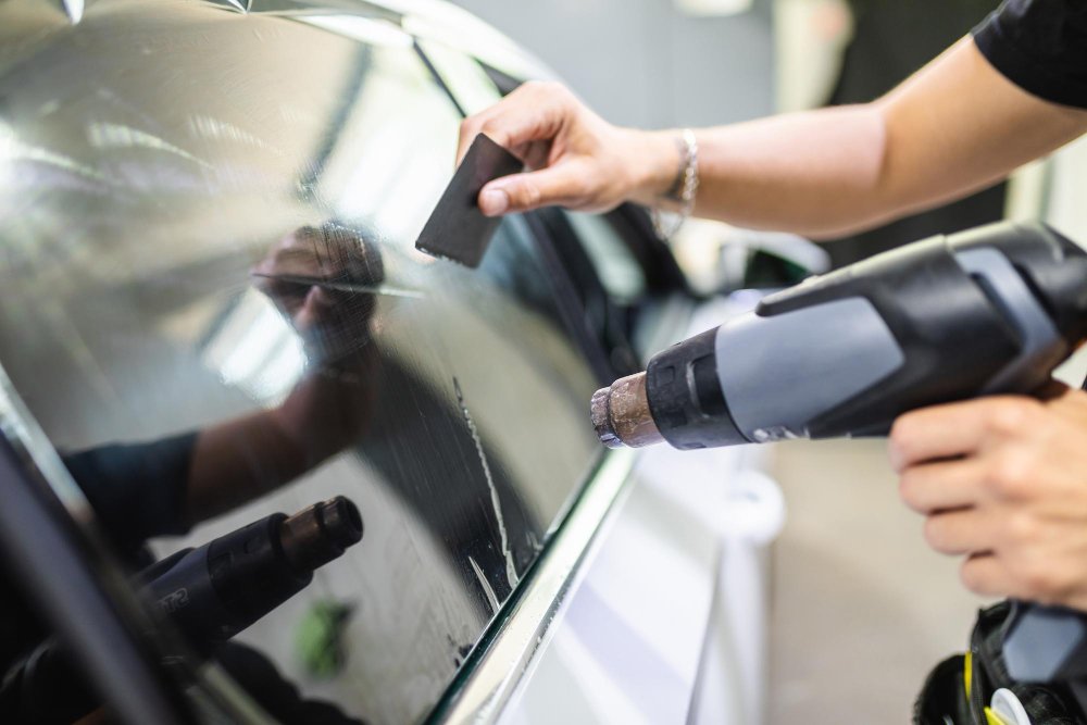 car-tinting-worker-applying-tinting-foil-car-window